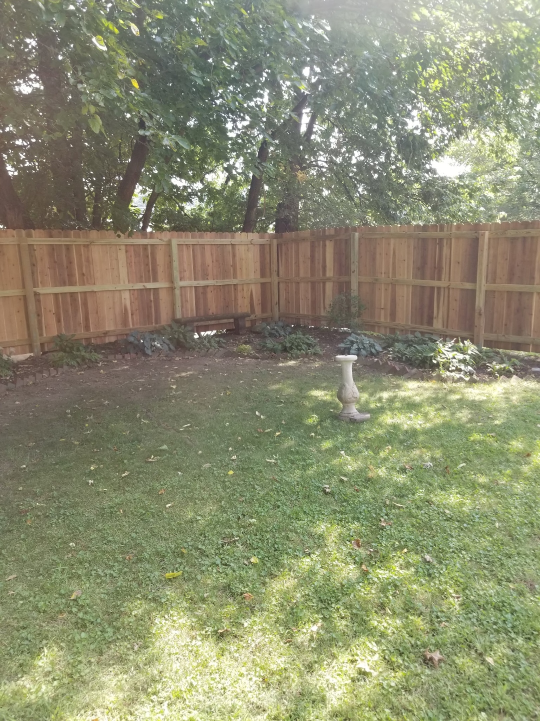 Cedar privacy fence with lush garden beds, Webster Groves MO