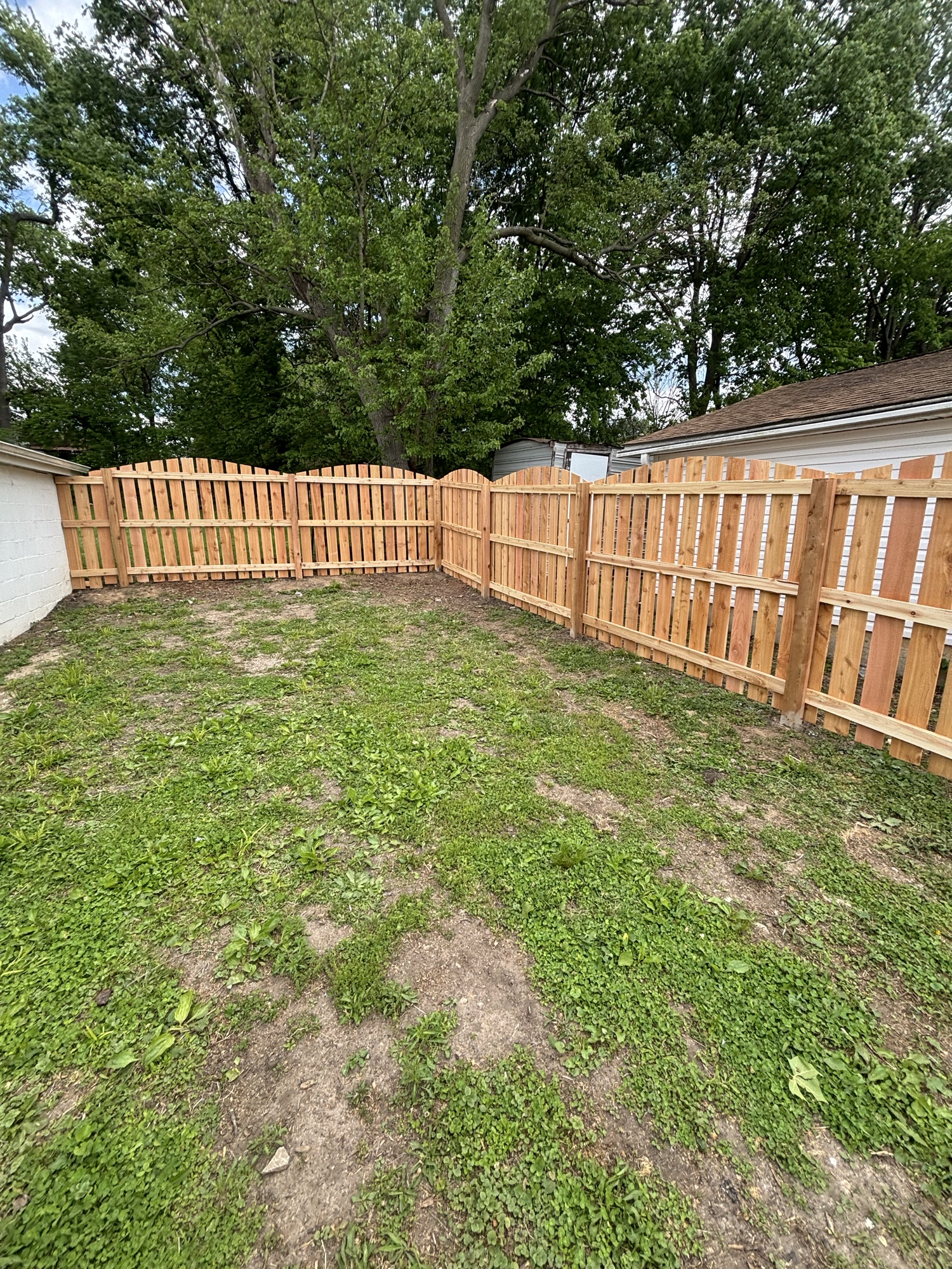 Cedar shadowbox fence with arched panels installed